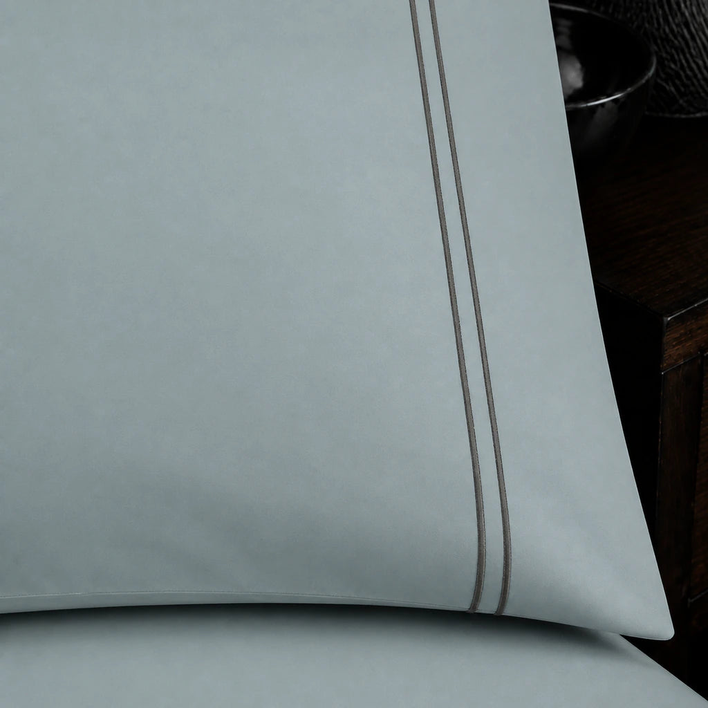 Close-up of duck egg pillowcase with two row grey satin stitch border by Linen and Co