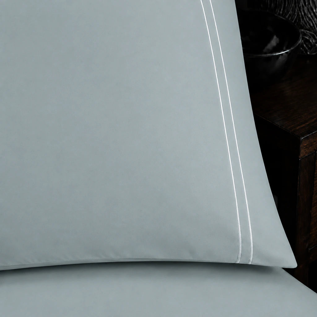Close-up of duck egg pillowcase with two row white satin stitch border by Linen and Co