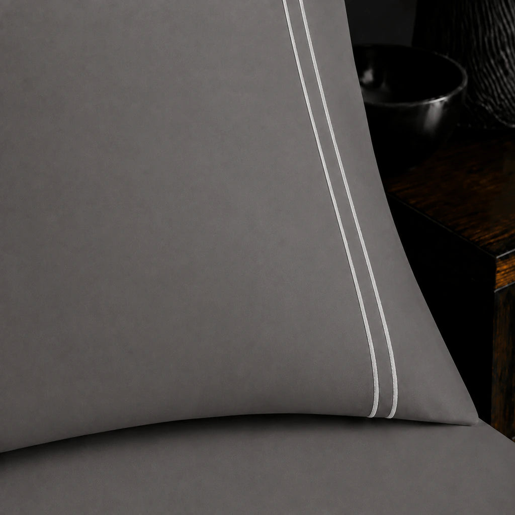 Close-up of grey pillowcase with two row white satin stitch border by Linen and Co