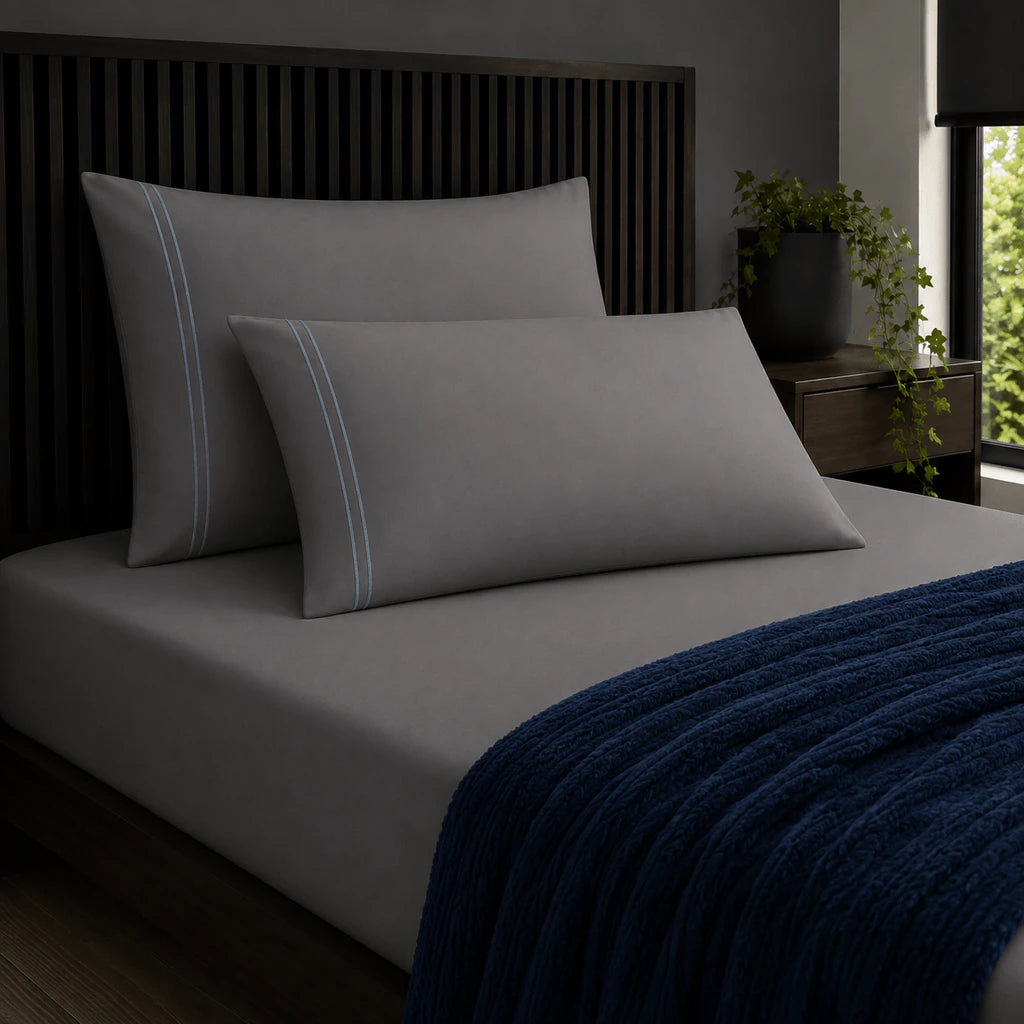 Plain grey 200TC 100% cotton percale pillowcases with two row duck egg satin stitch border by Linen and Co