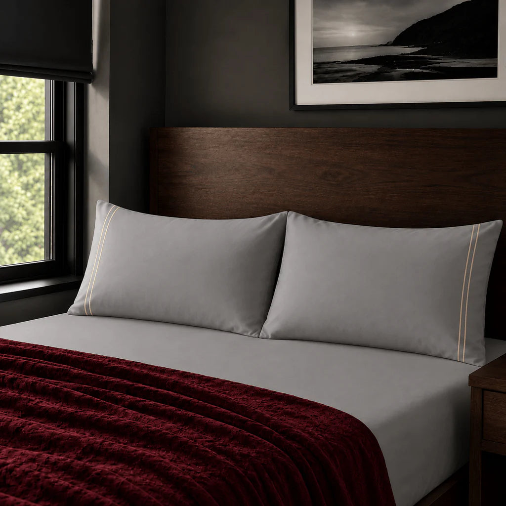 Plain grey 200TC polycotton percale pillowcases with two row stone satin stitch border by Linen and Co