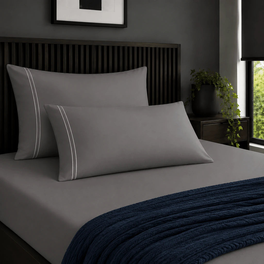 Plain grey 200TC 100% cotton percale pillowcases with two row white satin stitch border by Linen and Co