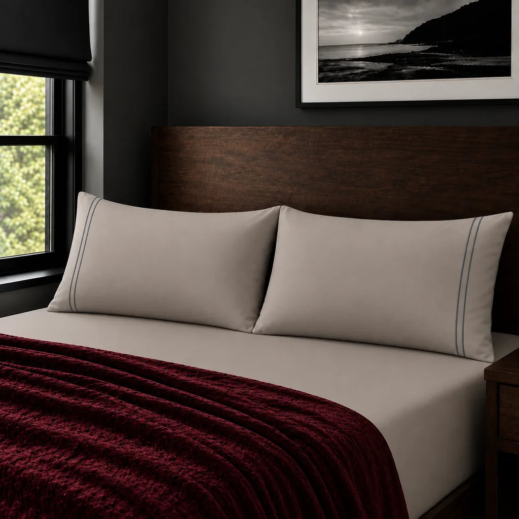 Plain stone 200TC polycotton percale pillowcases with two row grey satin stitch border by Linen and Co