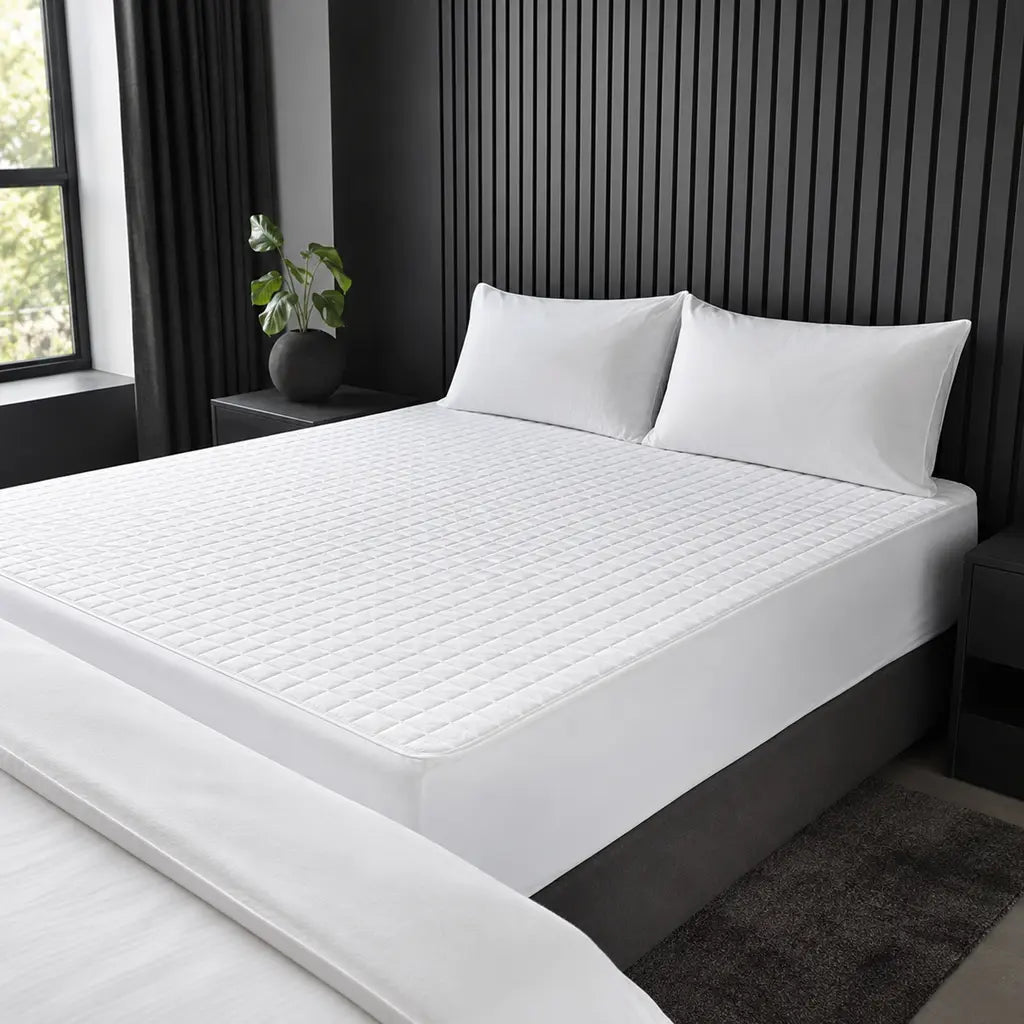 Quilted Wetsafe mattress protector in a cool grey bedroom by Linen and Co