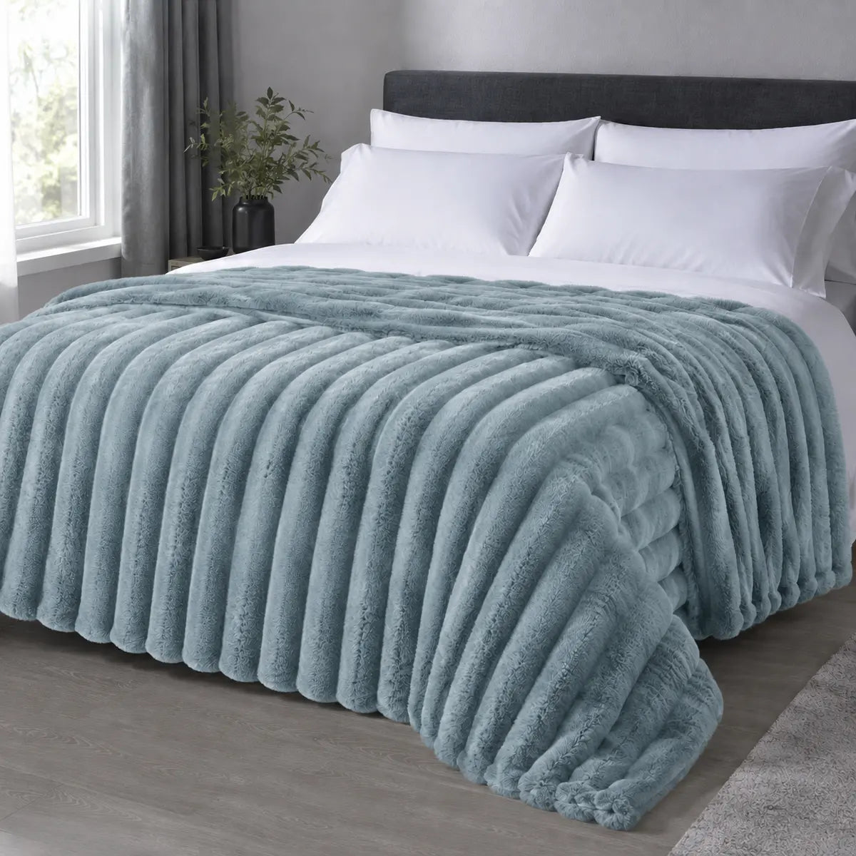 Marine ribbed faux fur blanket draped over a bed