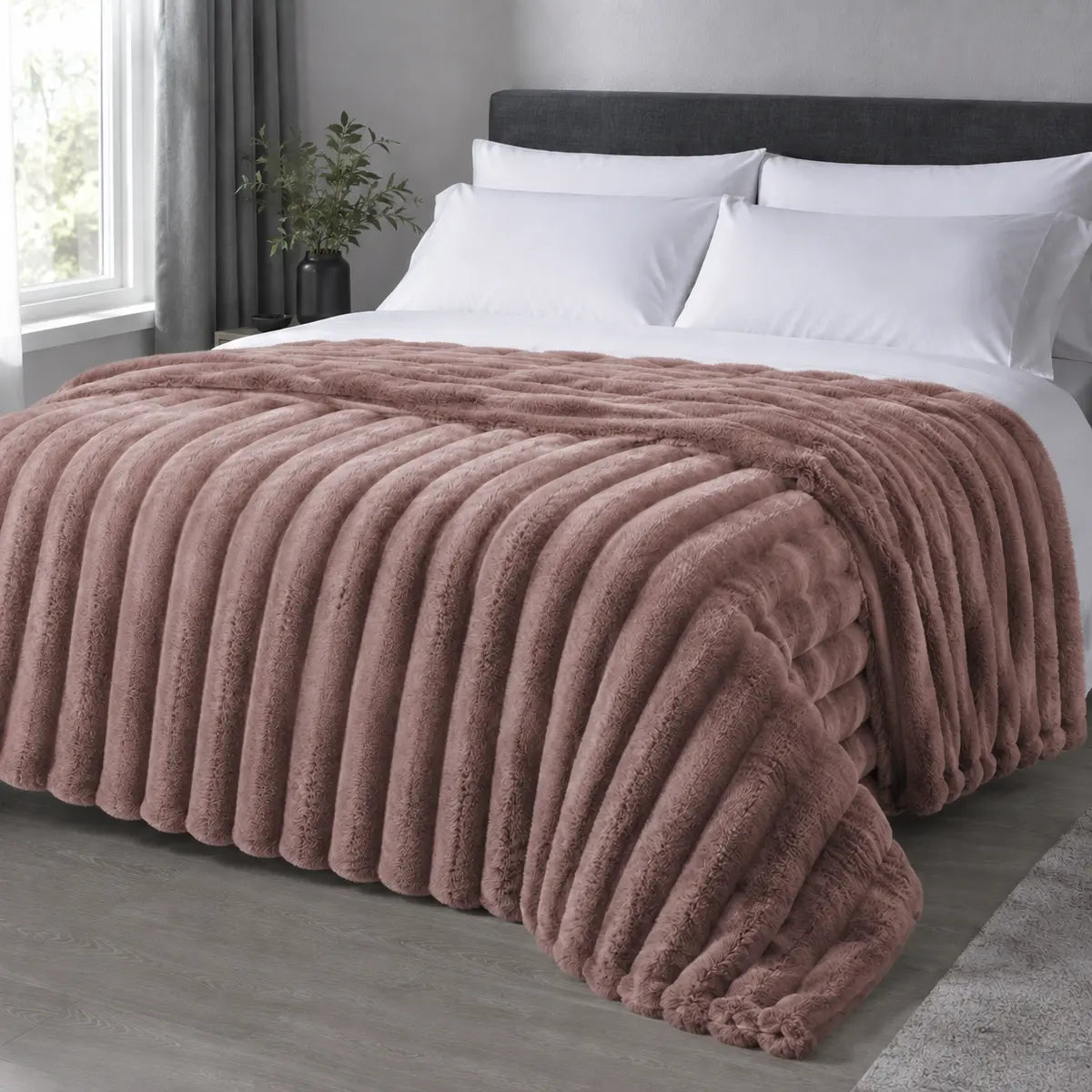 Rosewood ribbed faux fur blanket draped over a bed