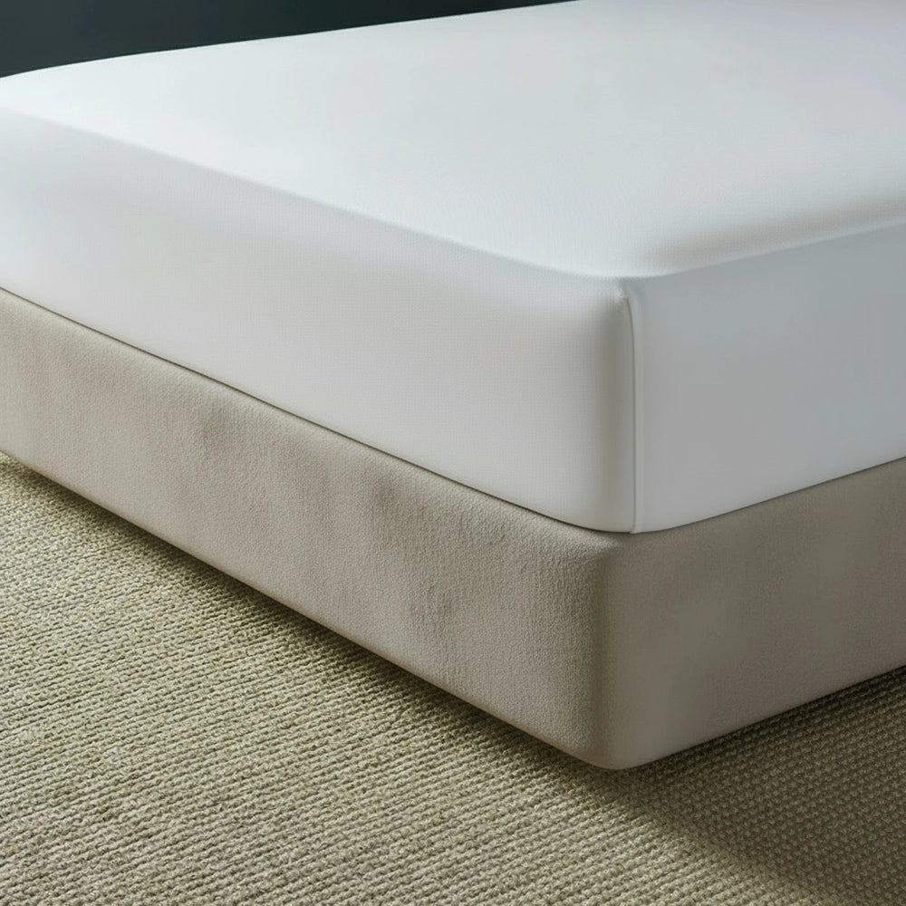 Stone mock suede base wrap covering bed base with white fitted sheet on beige jute mat—luxury bed base cover by Linen & Co