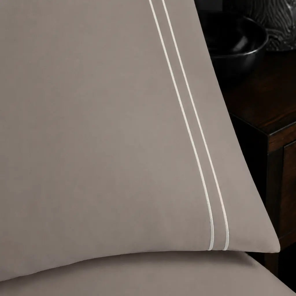 Close-up of a Stone Polycotton Percale 200TC pillowcase edge with two row Cream satin stitch.