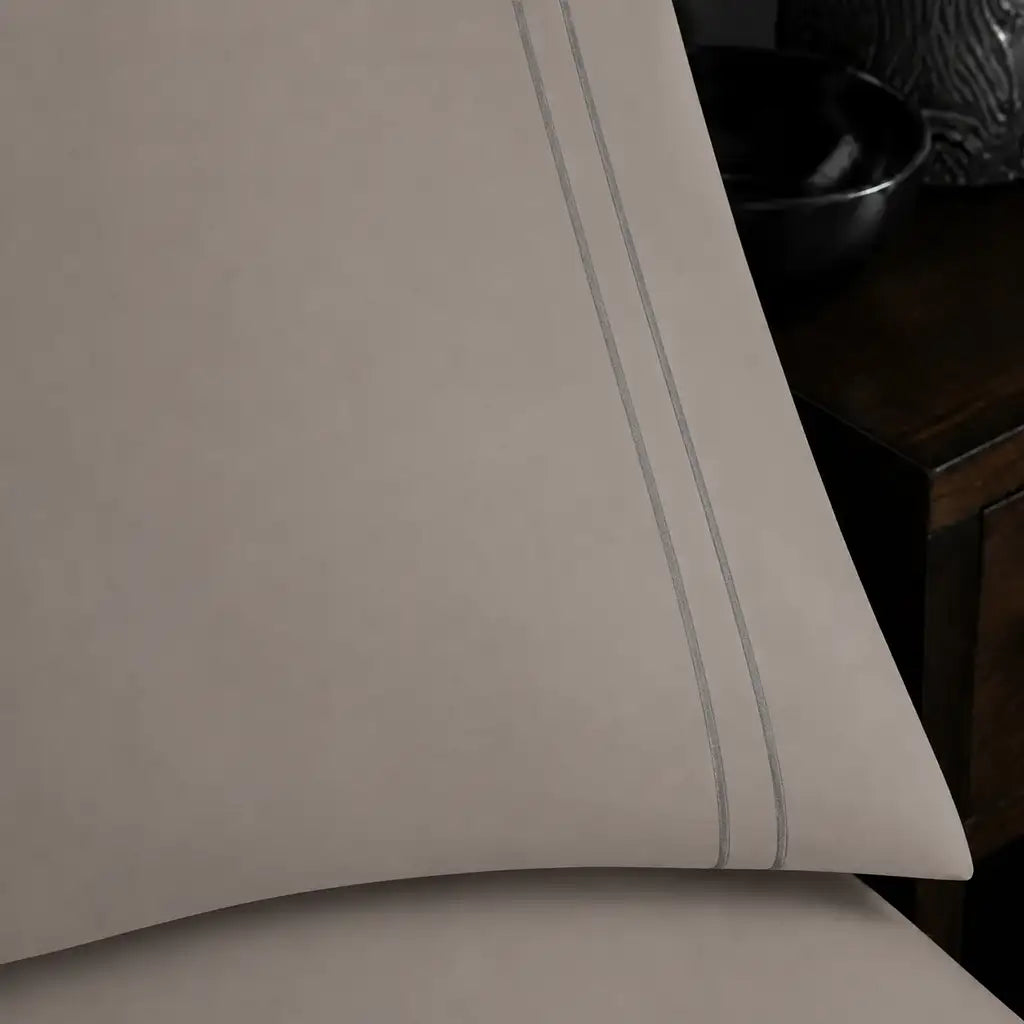 Close-up of a Stone Polycotton Percale 200TC pillowcase edge with two row of Grey satin stitch.
