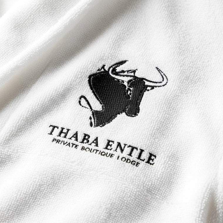 Logo embroidered on a white towelling gown