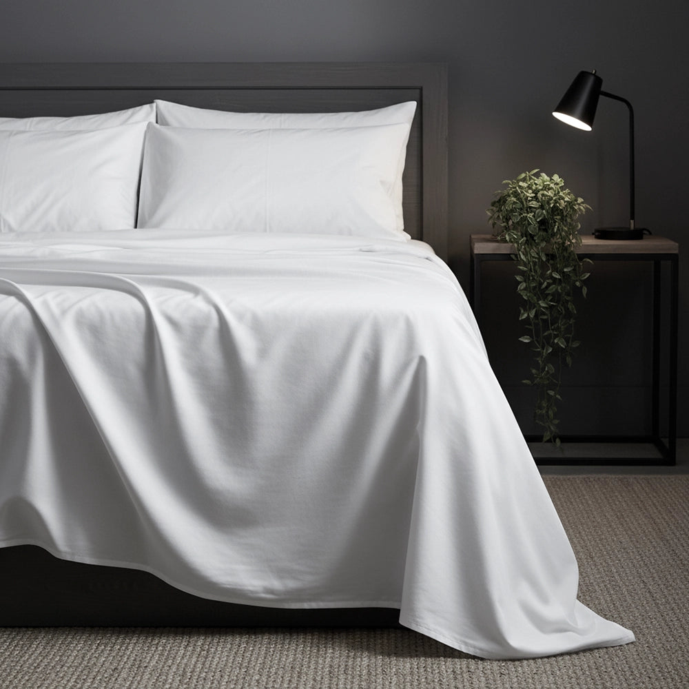 White flat sheet in hotel setting by Linen and Co - premium hospitality bed linen
