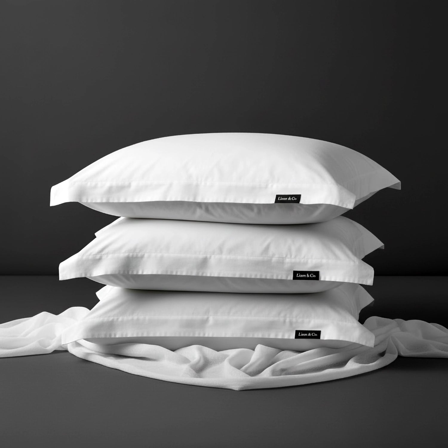 White oxford cotton percale 200TC pillowcases by Linen and Co, stacked to showcase crisp, durable hospitality-grade bed linen.