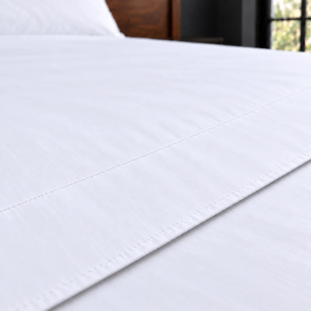 white polycotton percale 200tc flat sheet, plain no satin stitch — close up — Linen and Co