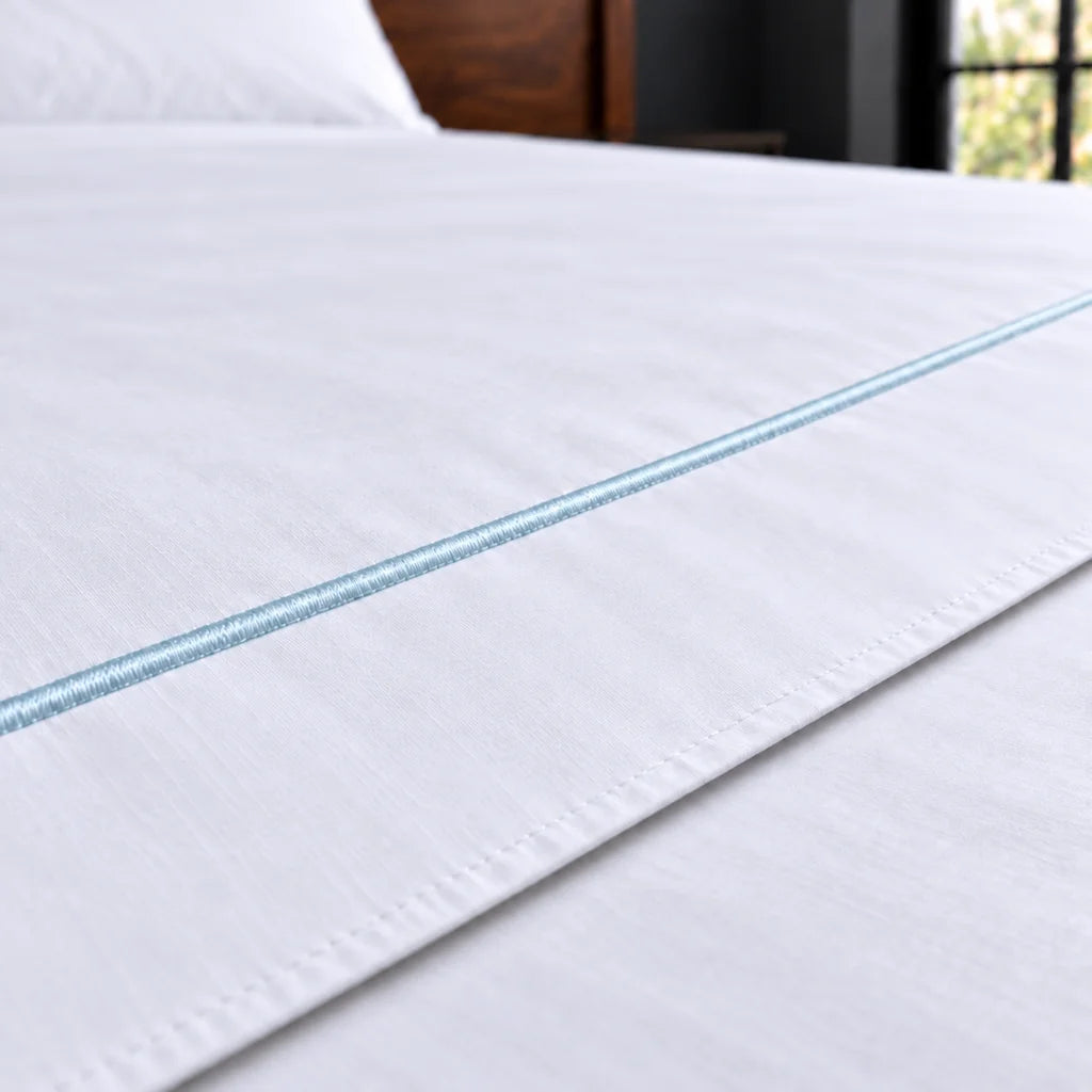 white polycotton percale 200tc flat sheet, one row duck egg satin stitch — close up — Linen and Co
