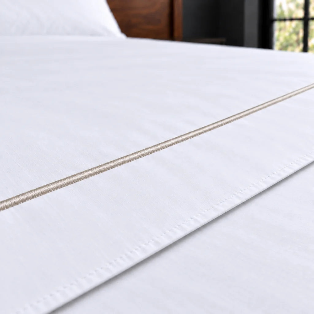 white polycotton percale 200tc flat sheet, one row stone satin stitch — close up — Linen and Co