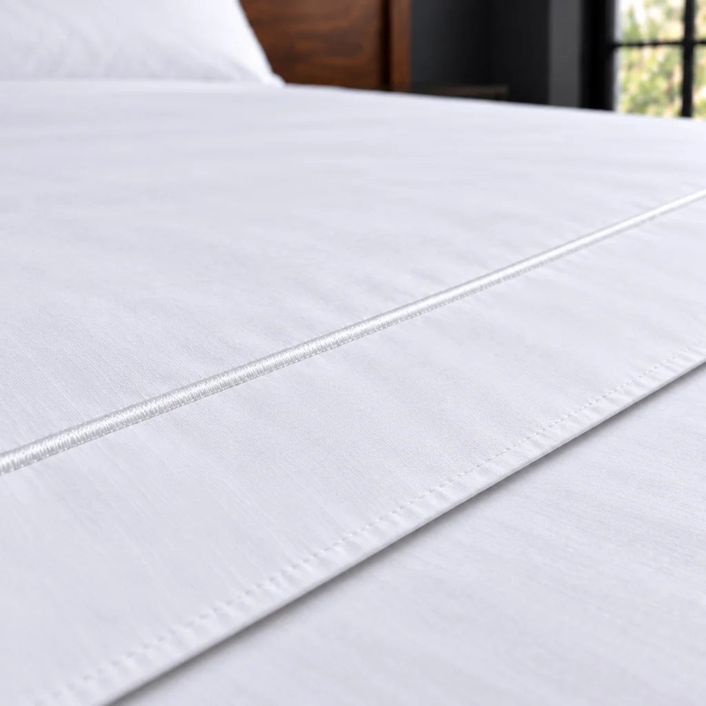 white polycotton percale 200tc flat sheet, one row white satin stitch — close up — Linen and Co