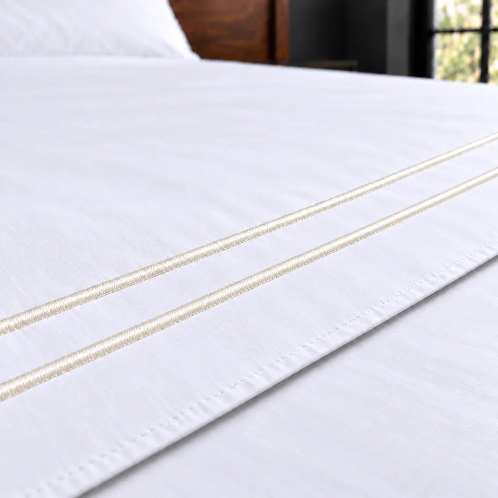 white polycotton percale 200tc flat sheet, two row cream satin stitch — close up — Linen and Co