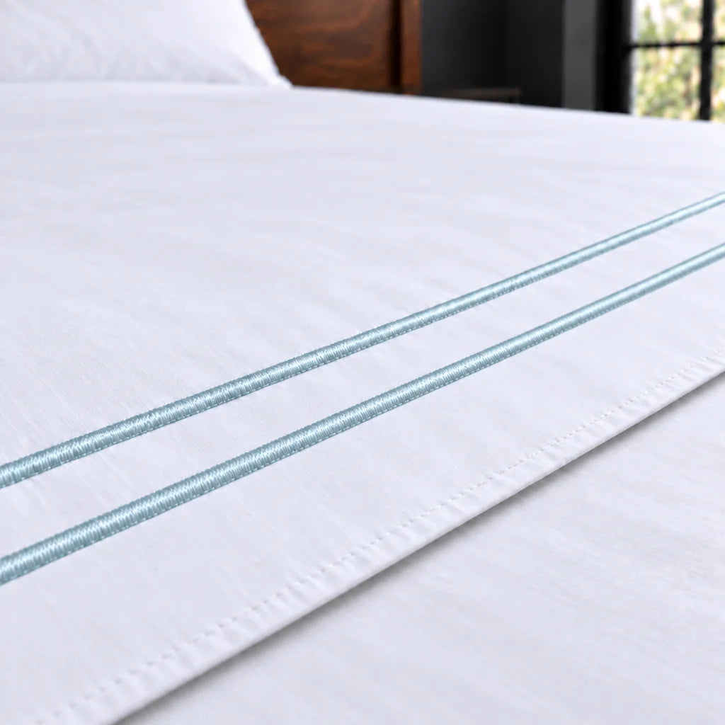 white polycotton percale 200tc flat sheet, two row duck egg satin stitch — close up — Linen and Co