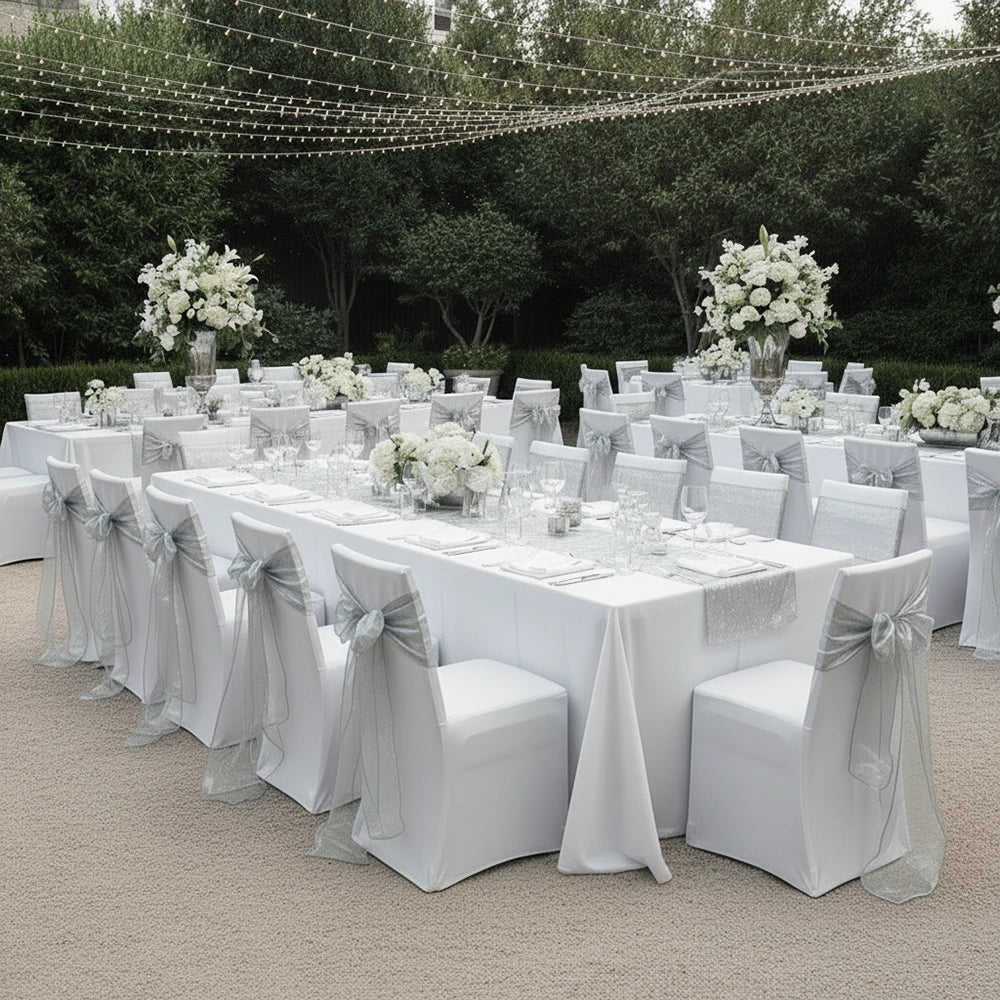 Elegant outdoor wedding setup with premium white table linen and decorated chairs by Linen and Co - luxury hospitality event linen
