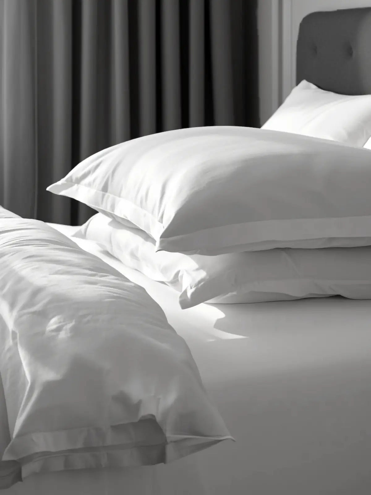 Crisp white bed linen on a guest-ready bed
